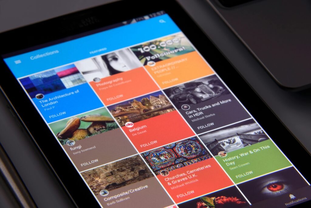 pexels-photo-242492-242492 Close-up of a tablet displaying diverse content collections in a grid format.